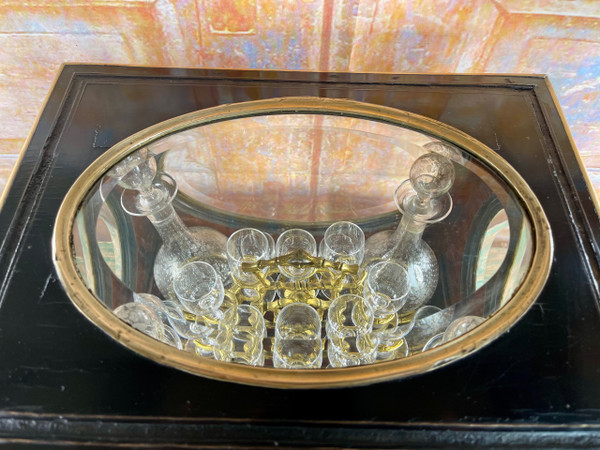 Napoleon III liqueur cellar in black wood, with brass fillets and chased glass portholes