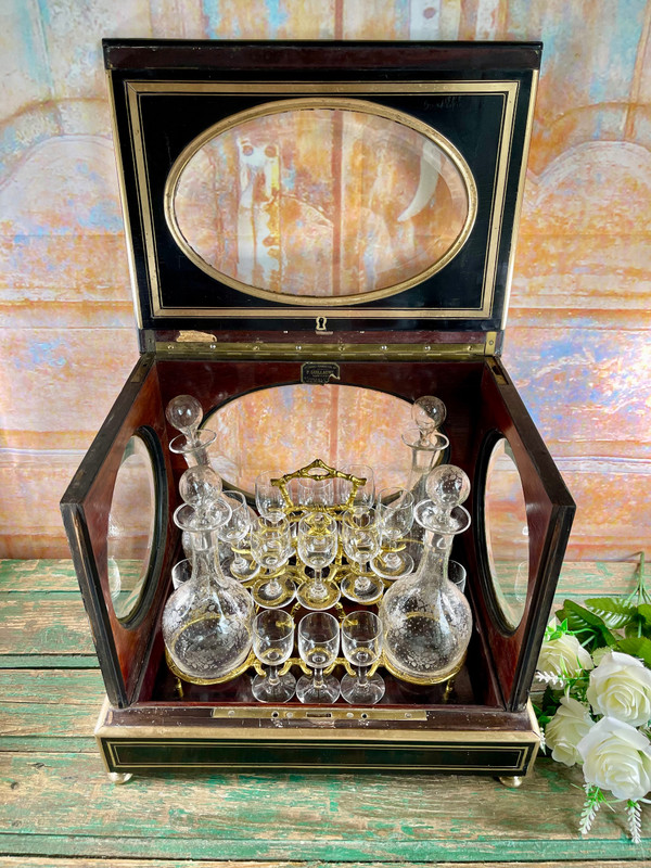 Napoleon III liqueur cellar in black wood, with brass fillets and chased glass portholes