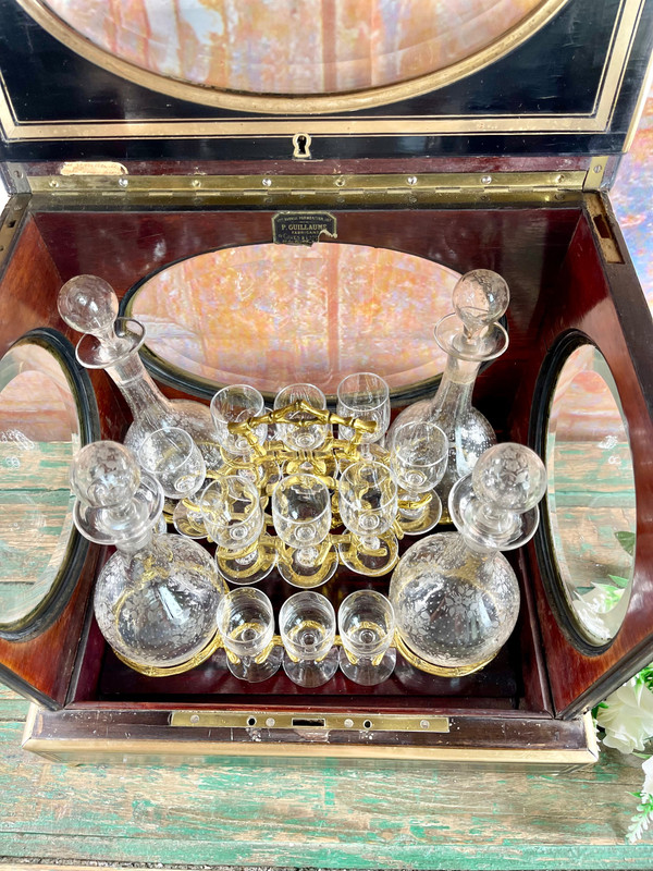 Napoleon III liqueur cellar in black wood, with brass fillets and chased glass portholes