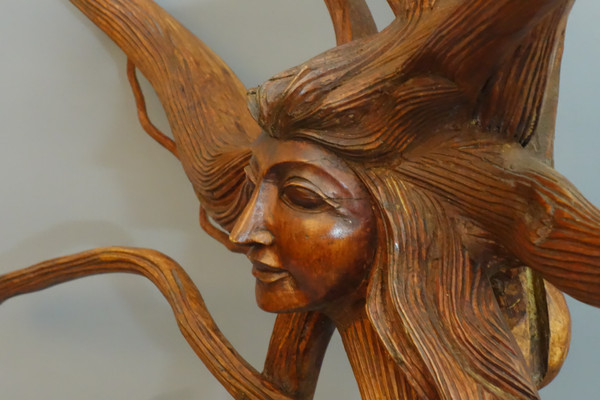 Scultura di un volto femminile con capelli luminosi