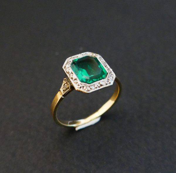 Antique ring set with an emerald and rose-cut diamonds.