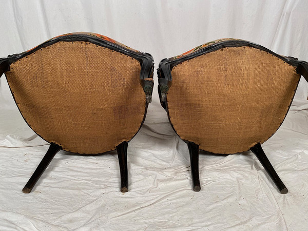 Pair of Napoleon III armchairs, in blackened wood, upholstered in floral fabric.