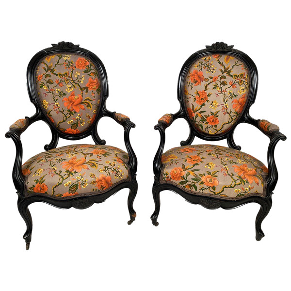 Pair of Napoleon III armchairs, in blackened wood, upholstered in floral fabric.