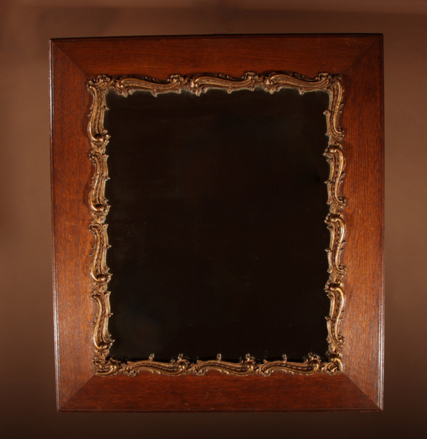 Original framed mirror in oak and gesso in the rococo style.