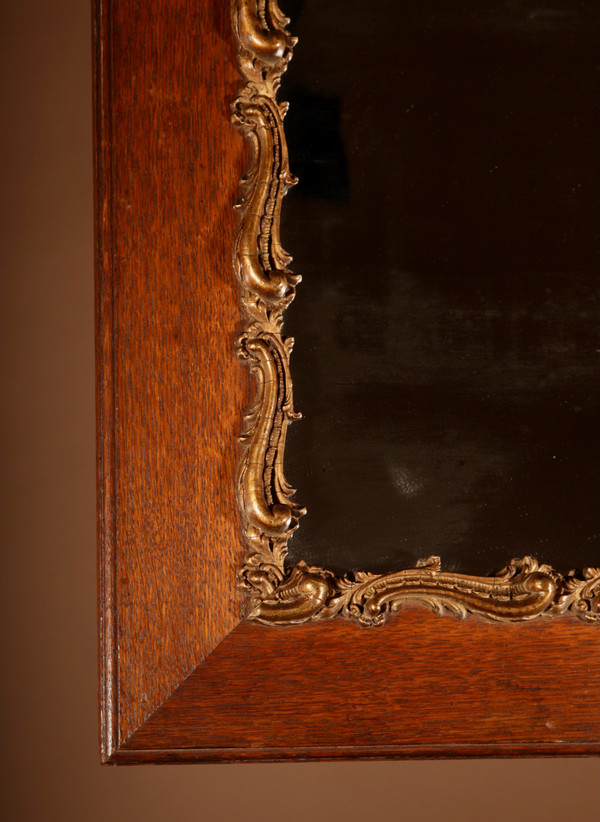 Original framed mirror in oak and gesso in the rococo style.