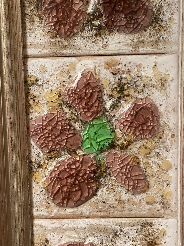 Large square ceramic mirror with floral decoration.