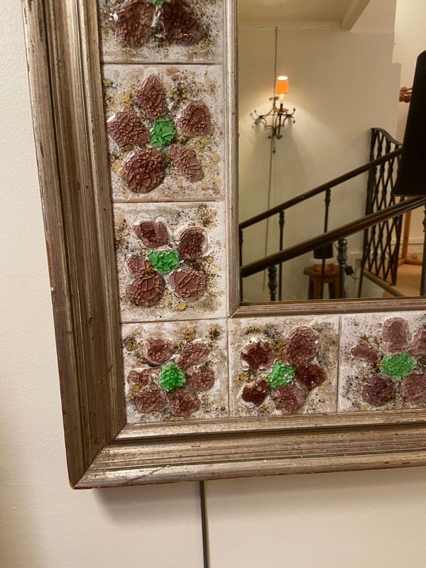 Large square ceramic mirror with floral decoration.