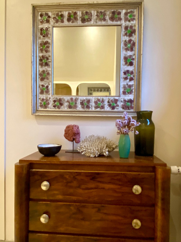 Large square ceramic mirror with floral decoration.