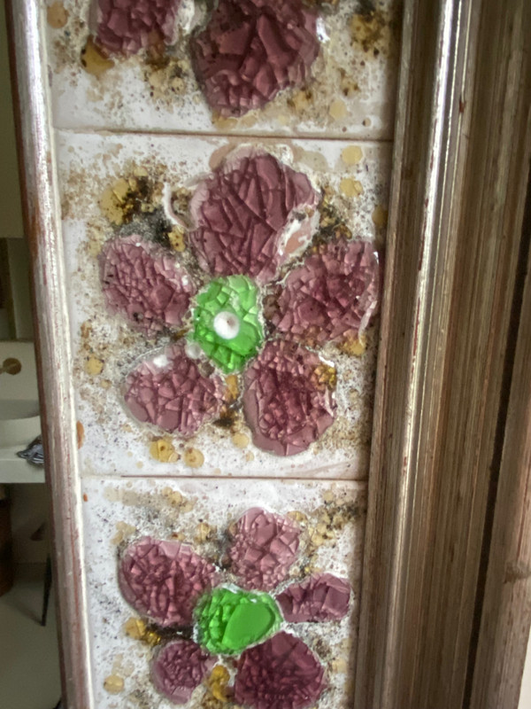 Large square ceramic mirror with floral decoration.