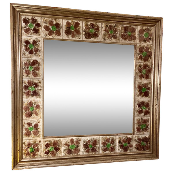 Large square ceramic mirror with floral decoration.