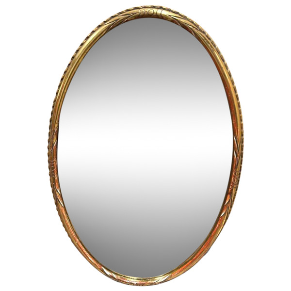 Oval mirror in gilded wood