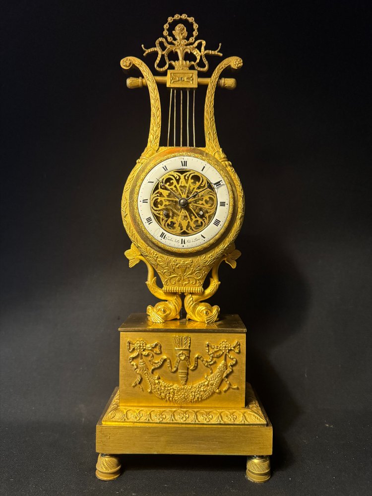 Empire period ormolu Lyre clock with dolphins