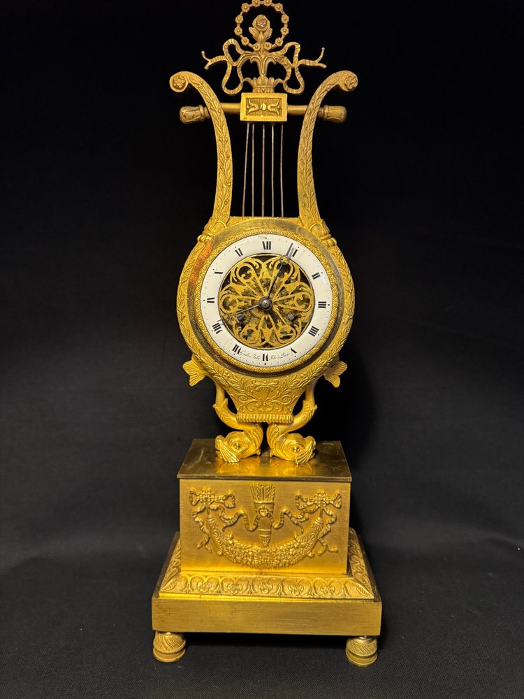 Empire period ormolu Lyre clock with dolphins