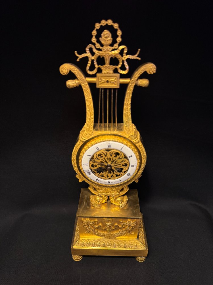 Empire period ormolu Lyre clock with dolphins