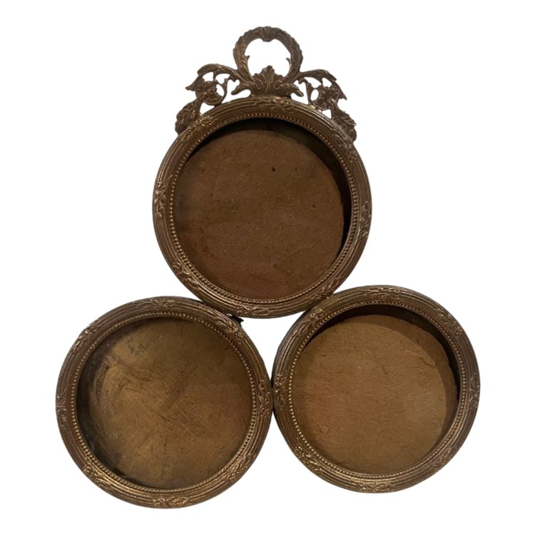 Three stacked brass picture frames