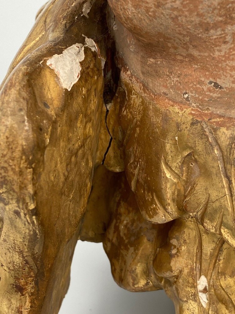 Head of a cherub in carved polychrome gilded wood, 17th century, entourage of Ignaz Günther