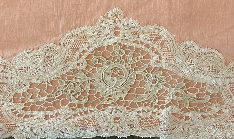  Lenzuolo e cuscino di lino rosa con pizzo Luxeuil decorato con fiori XIX secolo.