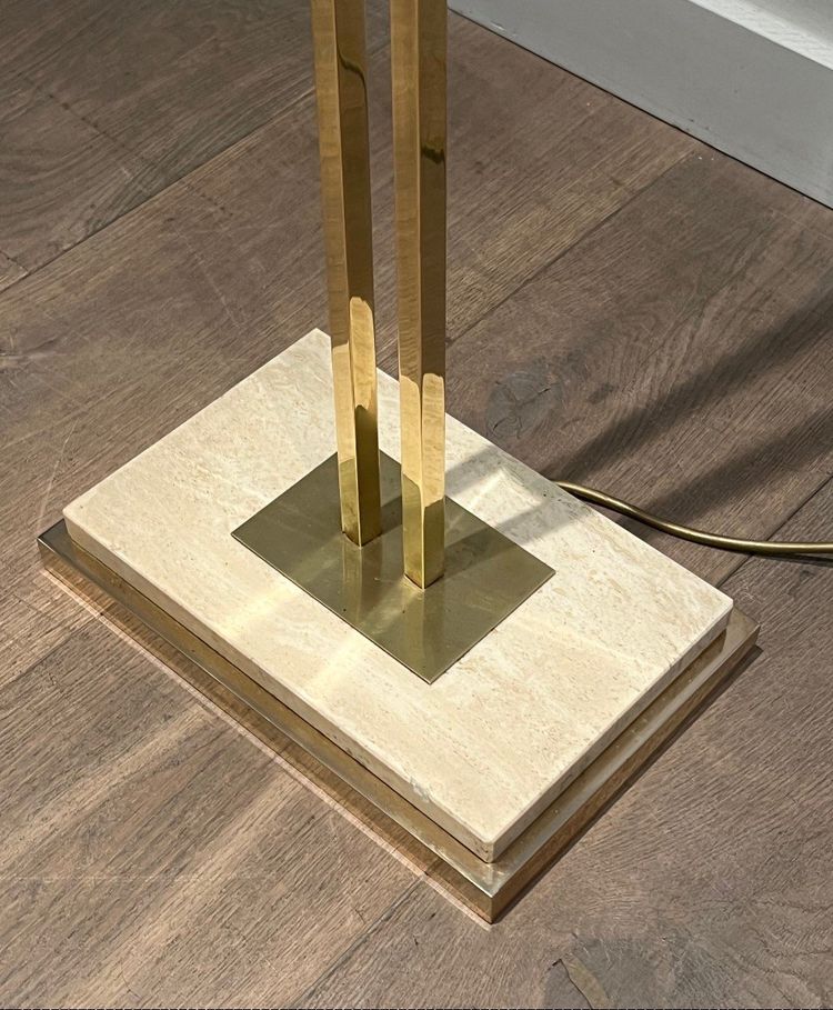 Lampada da terra in ottone con riflettore regolabile su base in travertino e ottone.
