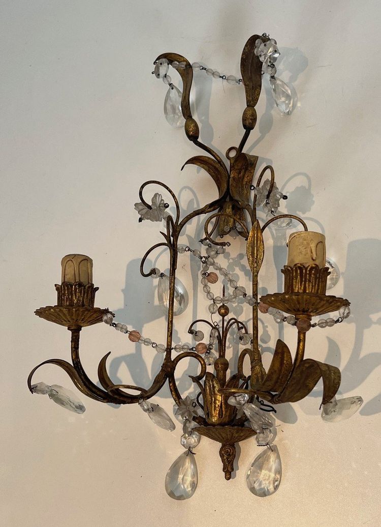 Pair of wall lights in gilded metal and crystals. French work in the style of Maison Baguès.