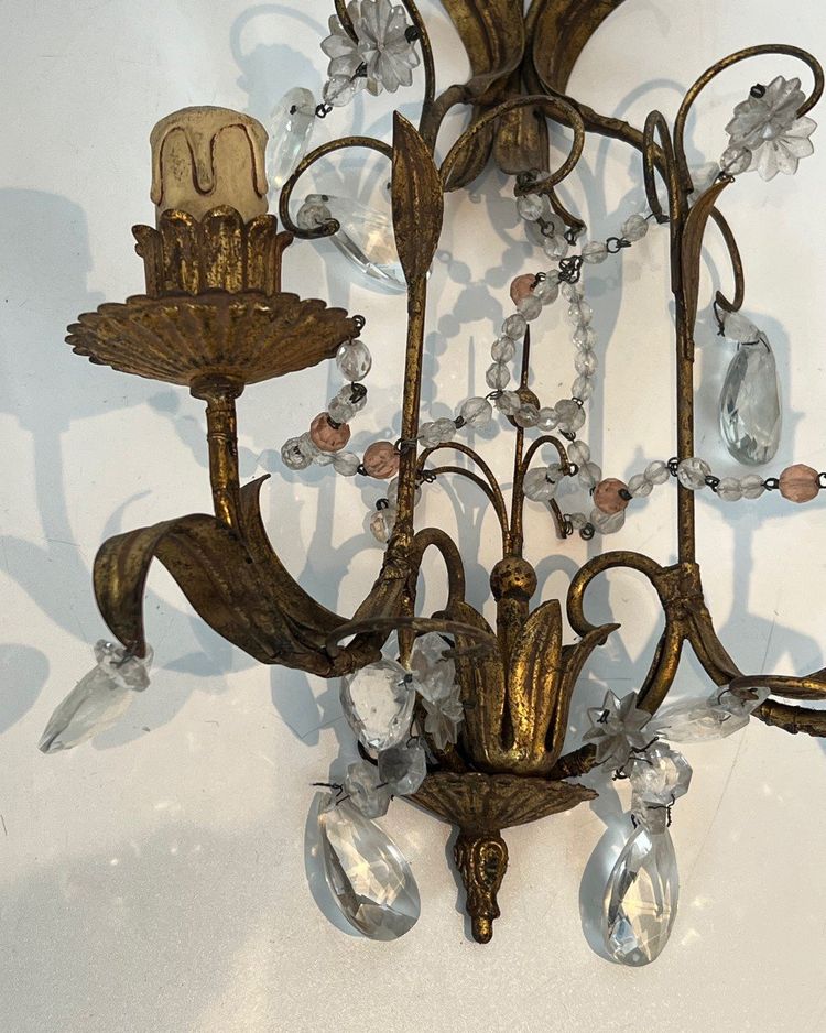 Pair of wall lights in gilded metal and crystals. French work in the style of Maison Baguès.