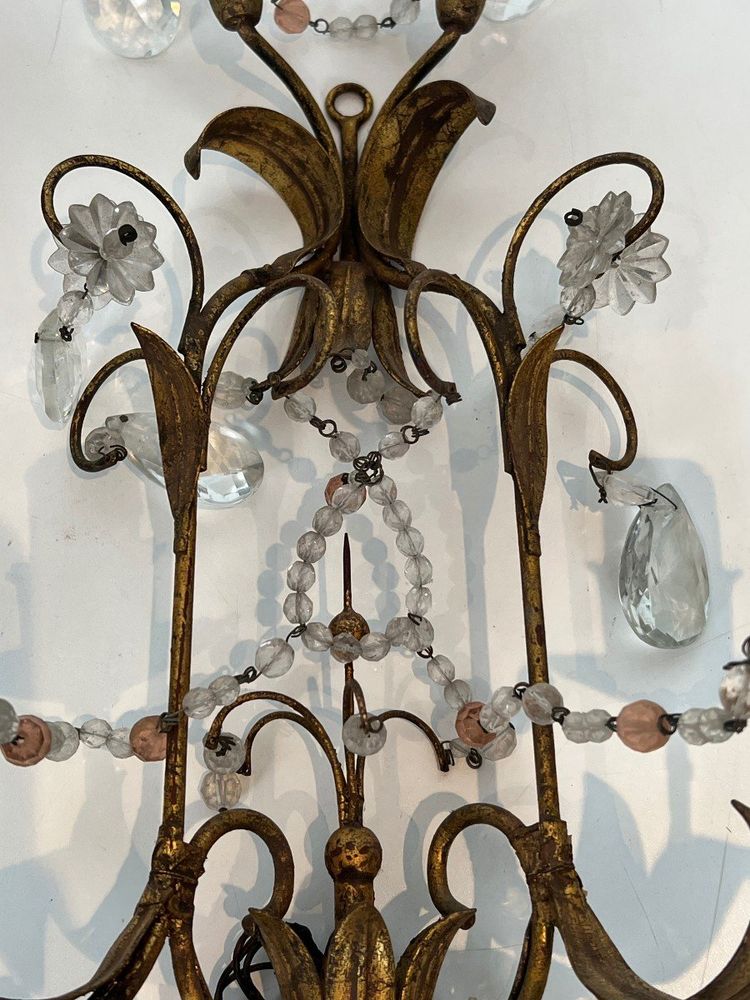 Pair of wall lights in gilded metal and crystals. French work in the style of Maison Baguès.