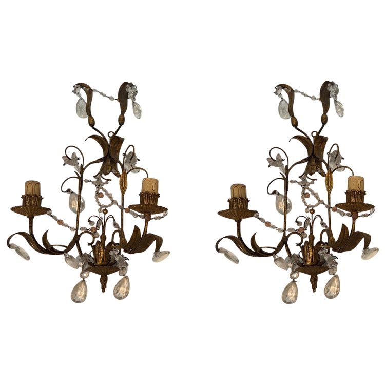 Pair of wall lights in gilded metal and crystals. French work in the style of Maison Baguès.
