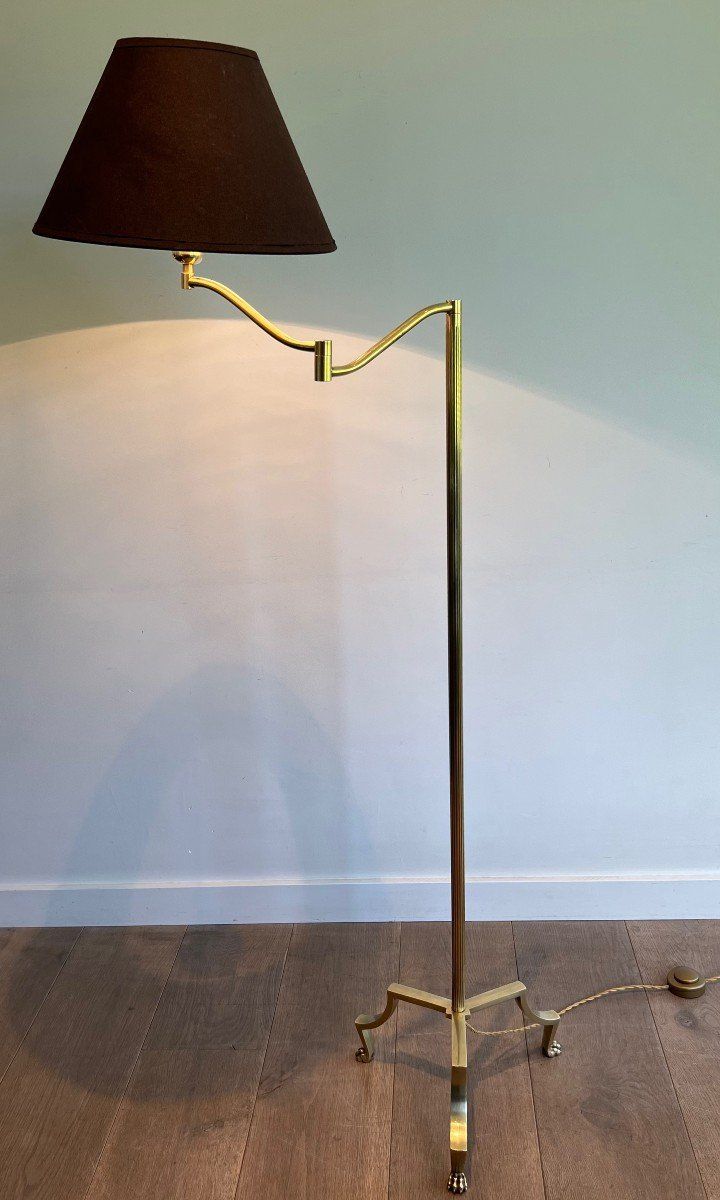 Brass reading lamp with removable, height-adjustable arm.