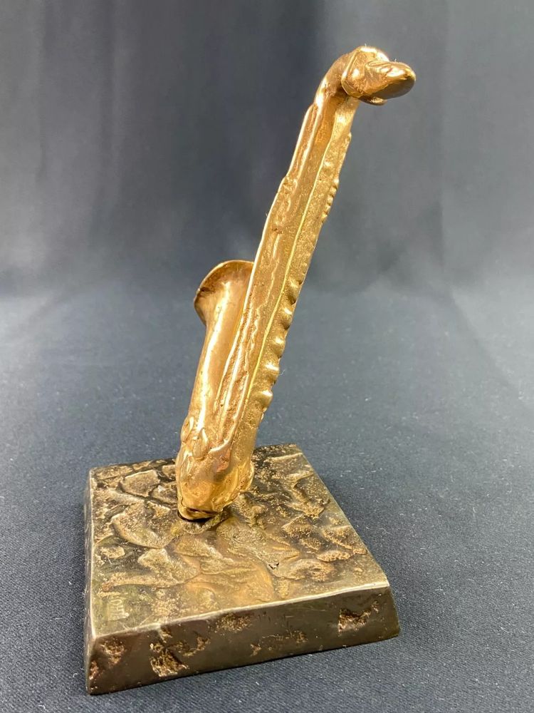Carved saxophone subject in bronze signed Yves Lohé