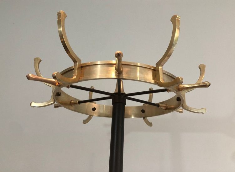 Appendiabiti in metallo laccato nero e ottone, opera francese di Jacques Adnet. Intorno al 1950