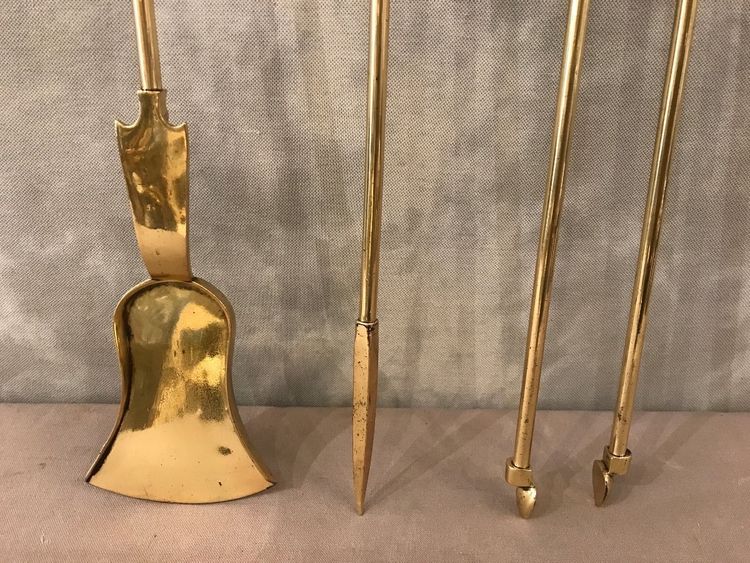 Set of three bronze and brass fireplace accessories from the 19th century.