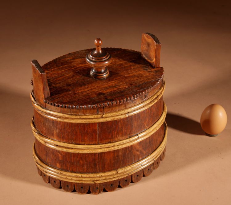 An oval oak butter pot.