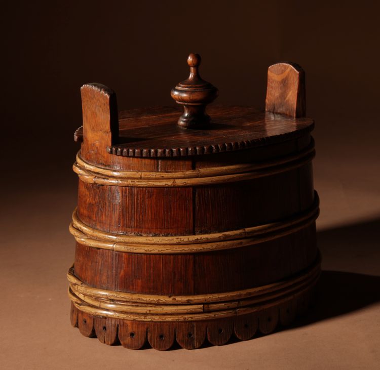 An oval oak butter pot.