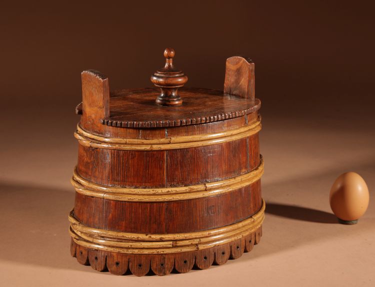 An oval oak butter pot.