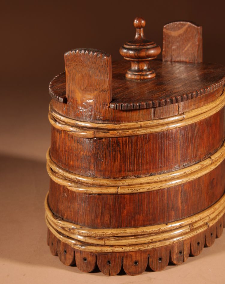 An oval oak butter pot.