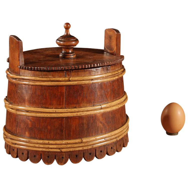 An oval oak butter pot.