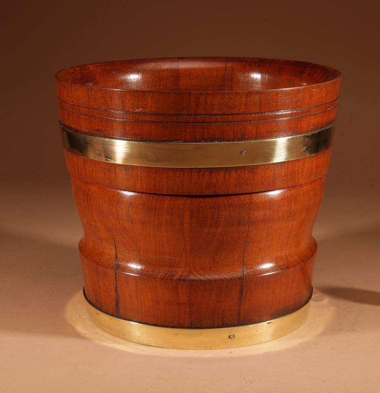 A large Dutch brass and turned teak planter/wine cooler, circa 1900