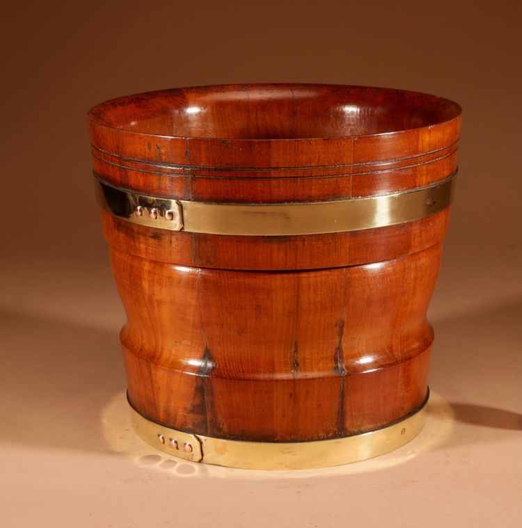 A large Dutch brass and turned teak planter/wine cooler, circa 1900