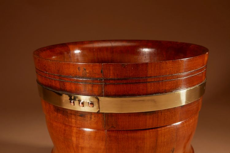 A large Dutch brass and turned teak planter/wine cooler, circa 1900