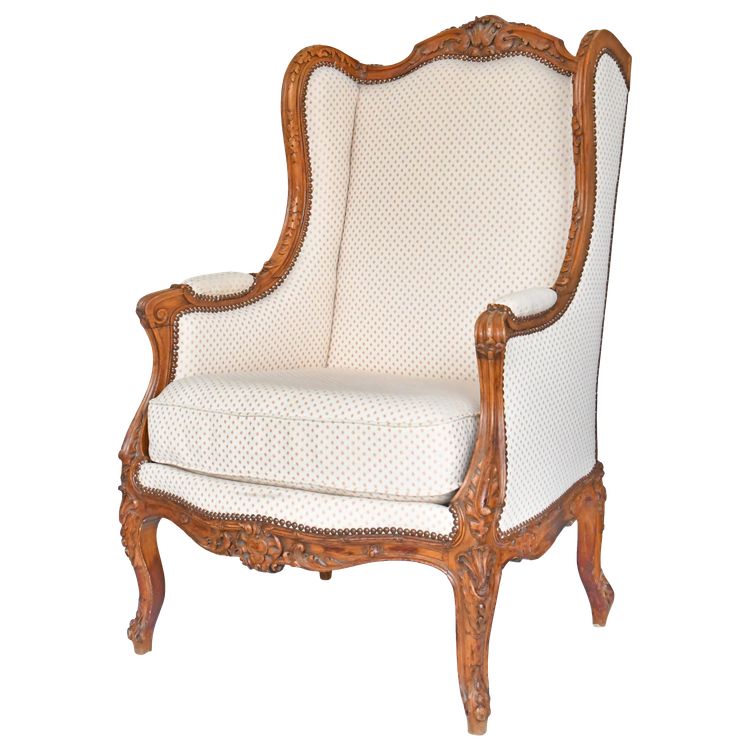 Fauteuil bergère à oreilles de style Louis XV en bois richement sculpté