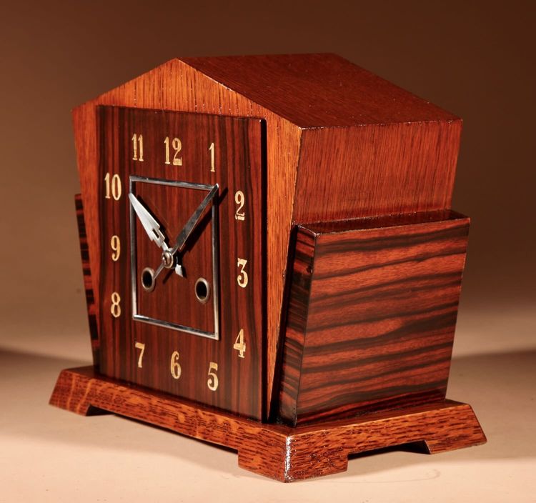  A very elegant mantel clock typical of the Amsterdam Art Deco school in oak and ebony from