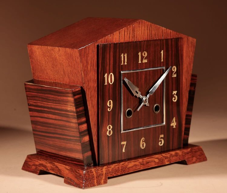  A very elegant mantel clock typical of the Amsterdam Art Deco school in oak and ebony from